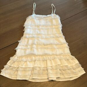 Very cute white dress with a zipper on the back and it’s a little of a slim fit